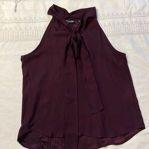 Dark purple blouse, sleeveless, elegant.